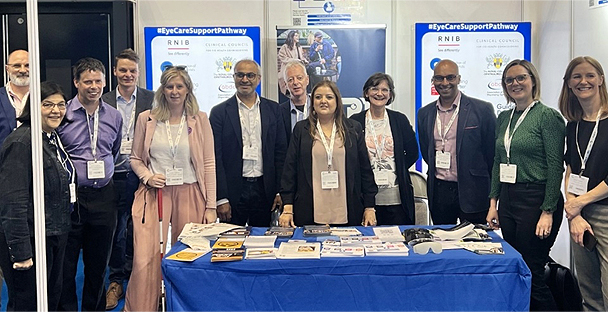 Image showing the Primary Eyecare Services’ team with members of third-sector organisations at their stand in the exhibition hall.